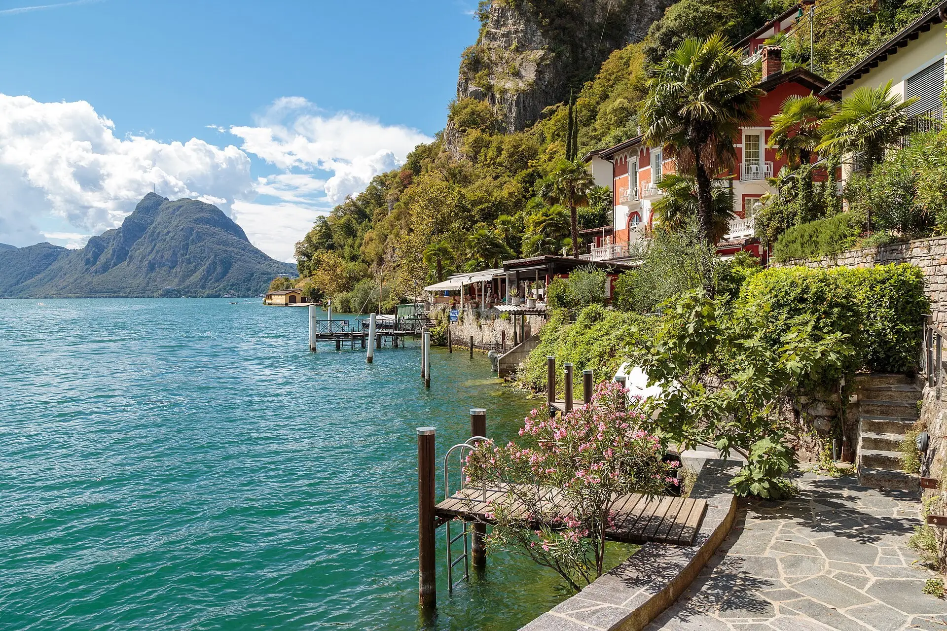 Stone houses of Gandria stacked above the water of Lake Lugano in late-afternoon light